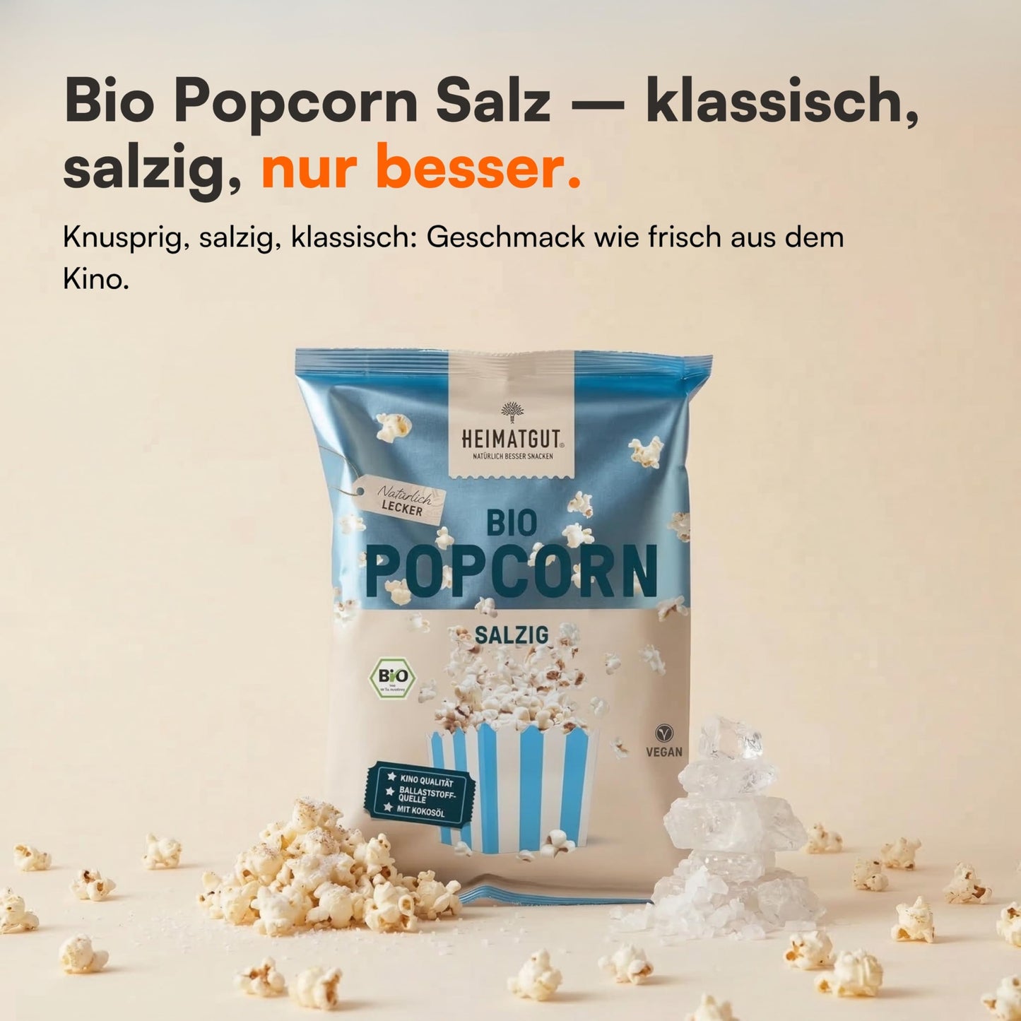 Tüte Bio Popcorn Salzig 60g von Heimatgut neben grobem Meersalz